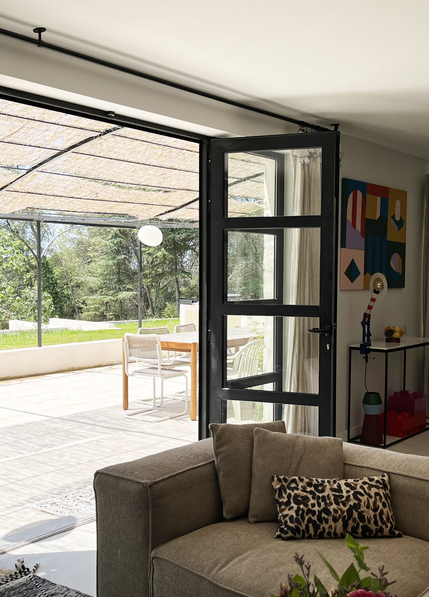 grande baie vitrée pergola fer forgé avec canisse ouverture façade rénovation maison provençale lumière salon Aix en Provence design fenêtre sur mesure